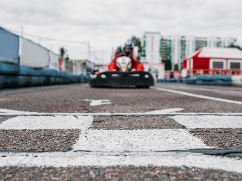 Karting racer on finish line, go kart competition. Carting championship